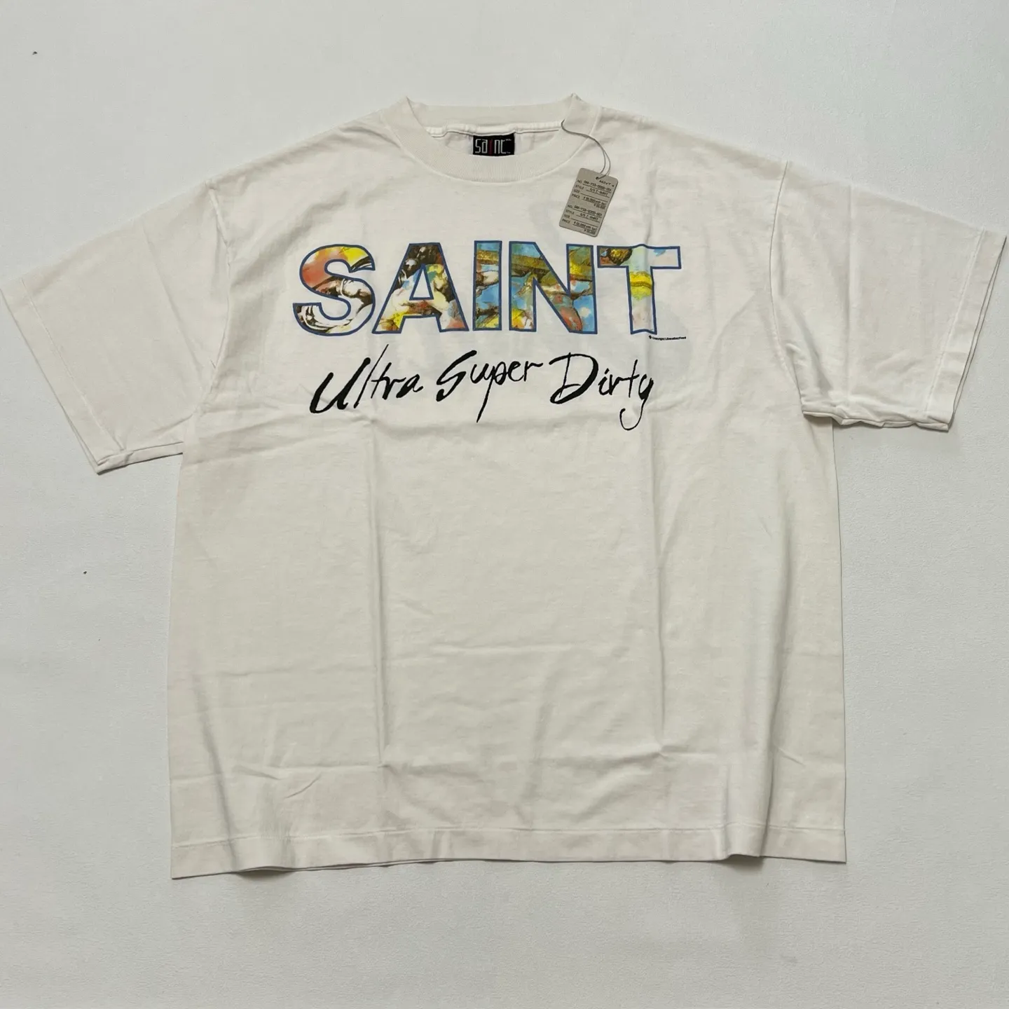 SAINT Mxxxxxx SS TEE/SUPER DIRTY/WHT oil painting SAINT SUPER DIRTY slogan TEE off-white S-XL Made of original OE yarn tube weaving without side seams to distinguish the split fabrics original consistent VINTAGE label/little angel anti-counterfeiting label top printing technology highly restored original details